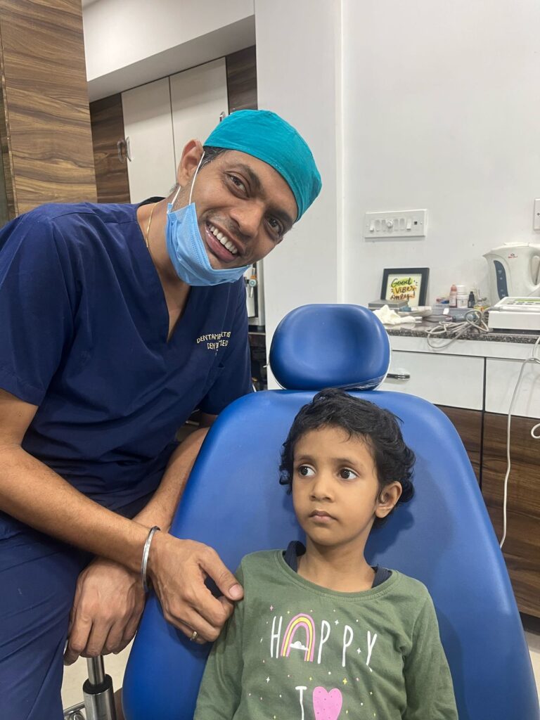 dr.deepesh jaiswal with one of his child patient at dentamedics